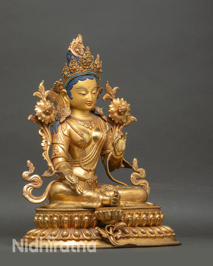 Side view of Green Tara statue with flowing robe and semi-precious stone details