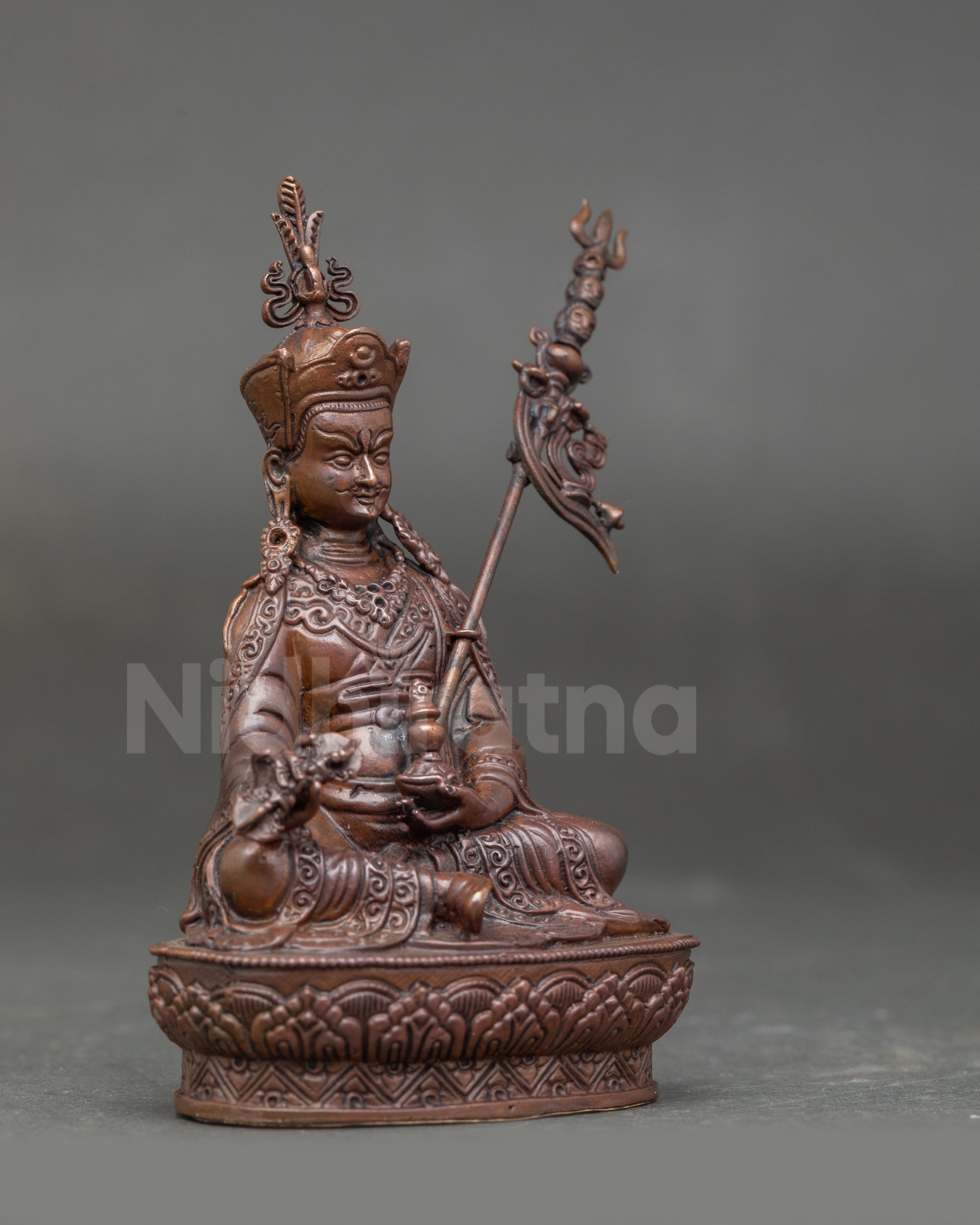 Side view of Guru Rinpoche Statue showing layered silk brocade robes and detailed jewelry