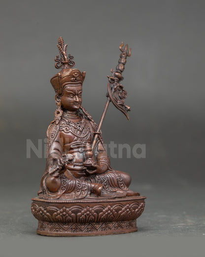 Side view of Guru Rinpoche Statue showing layered silk brocade robes and detailed jewelry