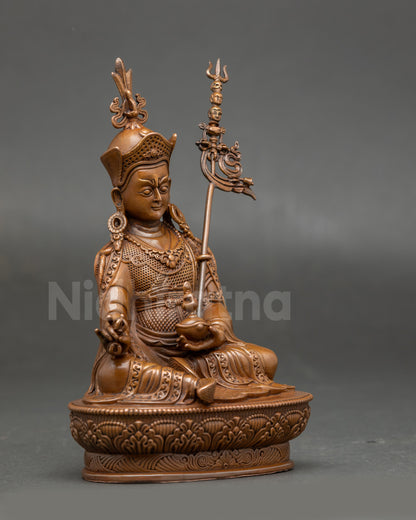 Side view of Guru Rinpoche oxidised statue showcasing layered robes and lotus seat