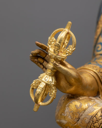 Side view of Guru Rinpoche sculpture with lotus base, ornate robes, and semi-precious stone