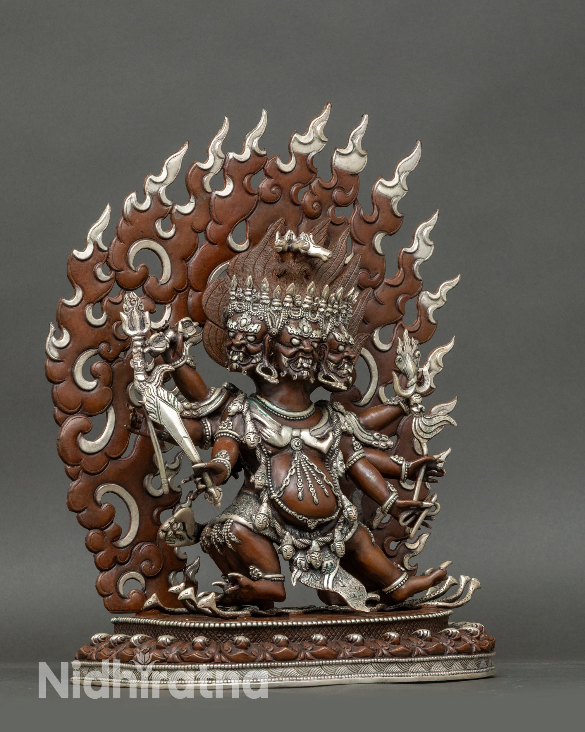 Side view of Hayagriva statue on lotus seat, displaying six arms holding sacred ritual objects