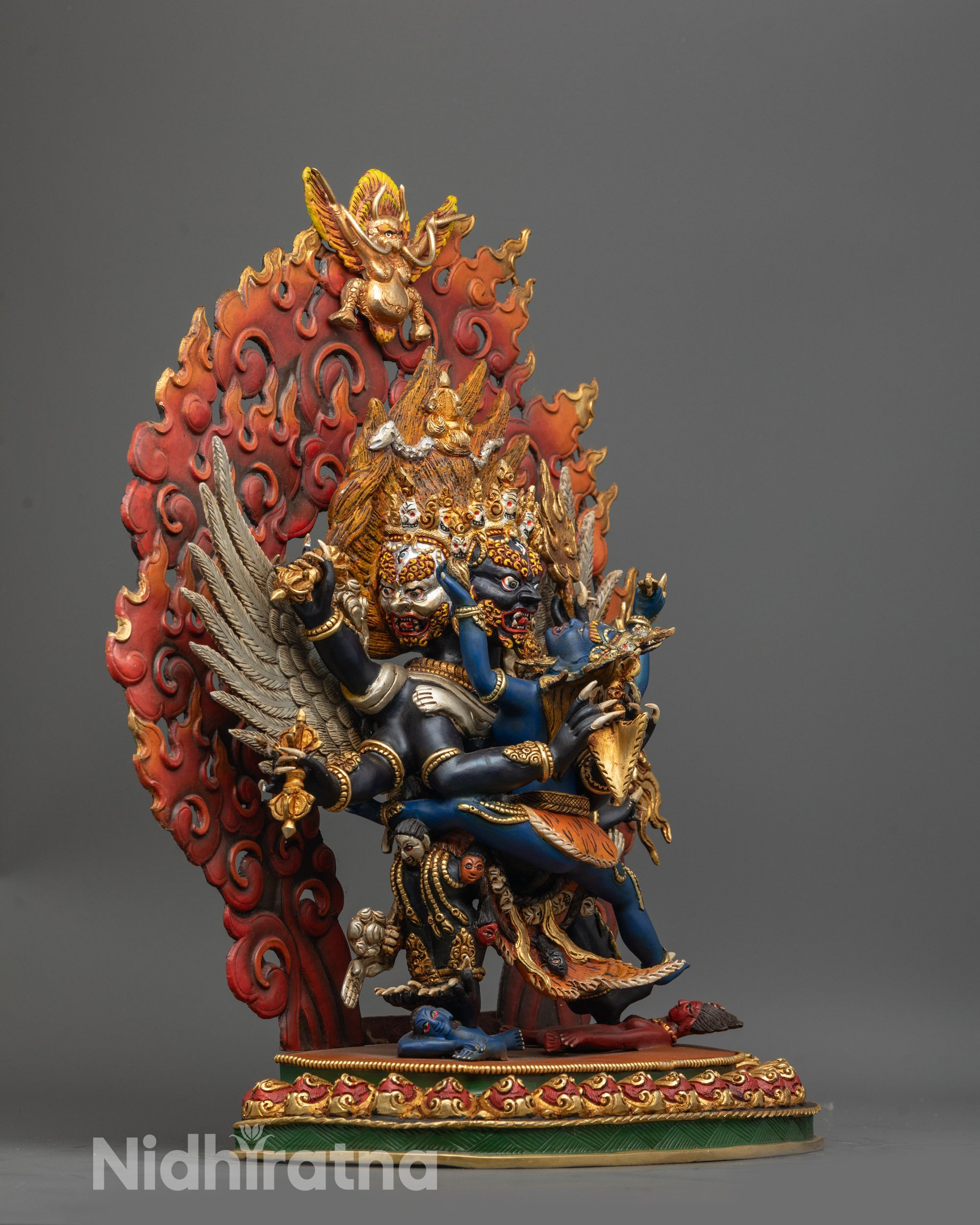 Side view of Himalayan Vajrakilaya consort statue with silver-plated wings and sacred objects