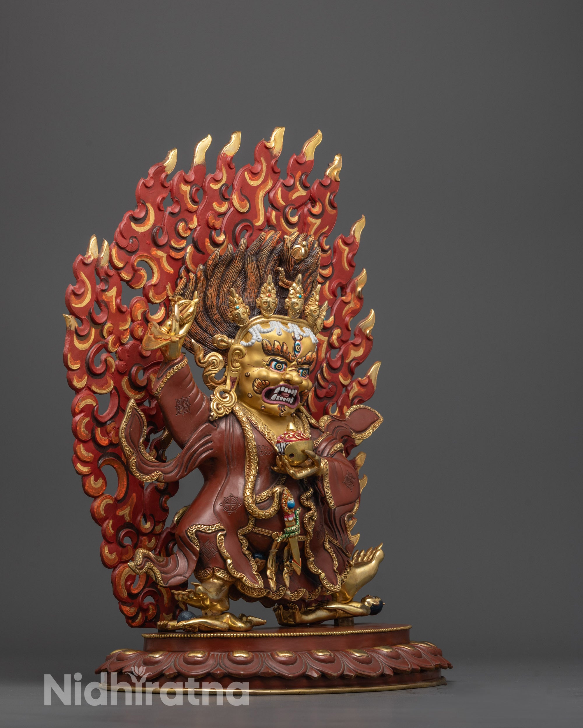 Side view of Mahakala Bernagchen standing on lotus seat above subdued figure
