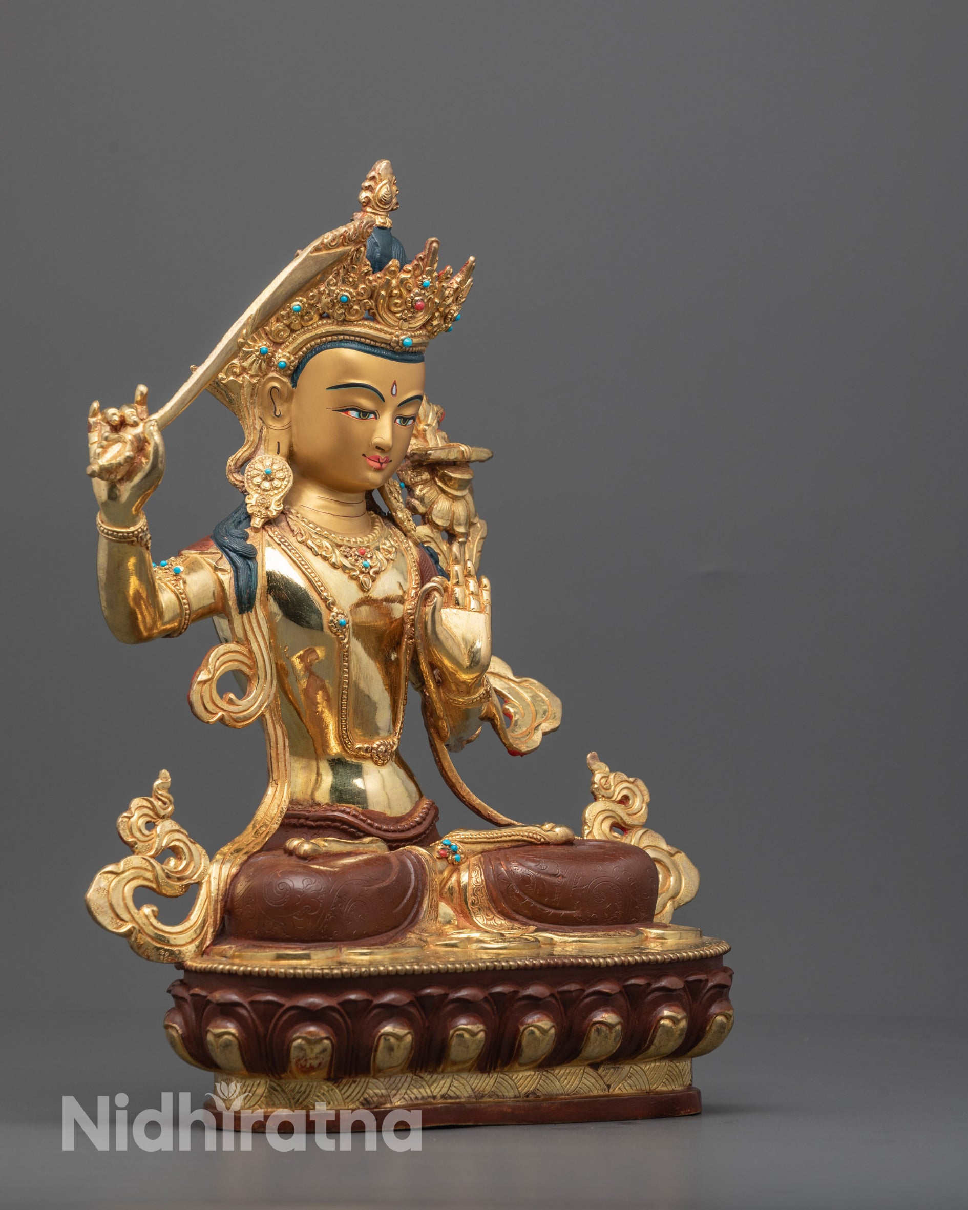 Side view of Manjushri Statue highlighting the intricate copper body