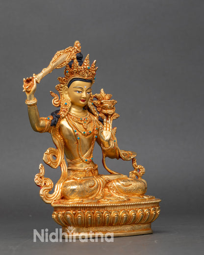 Side view of Manjushri statue, copper Buddhist deity artwork from Nepal