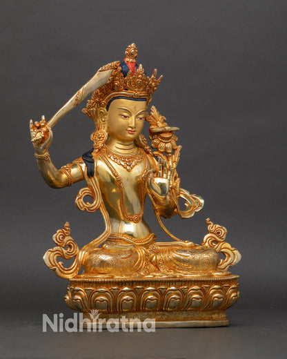 Side view of Manjushri statue on lotus throne, highlighting intricate copper details