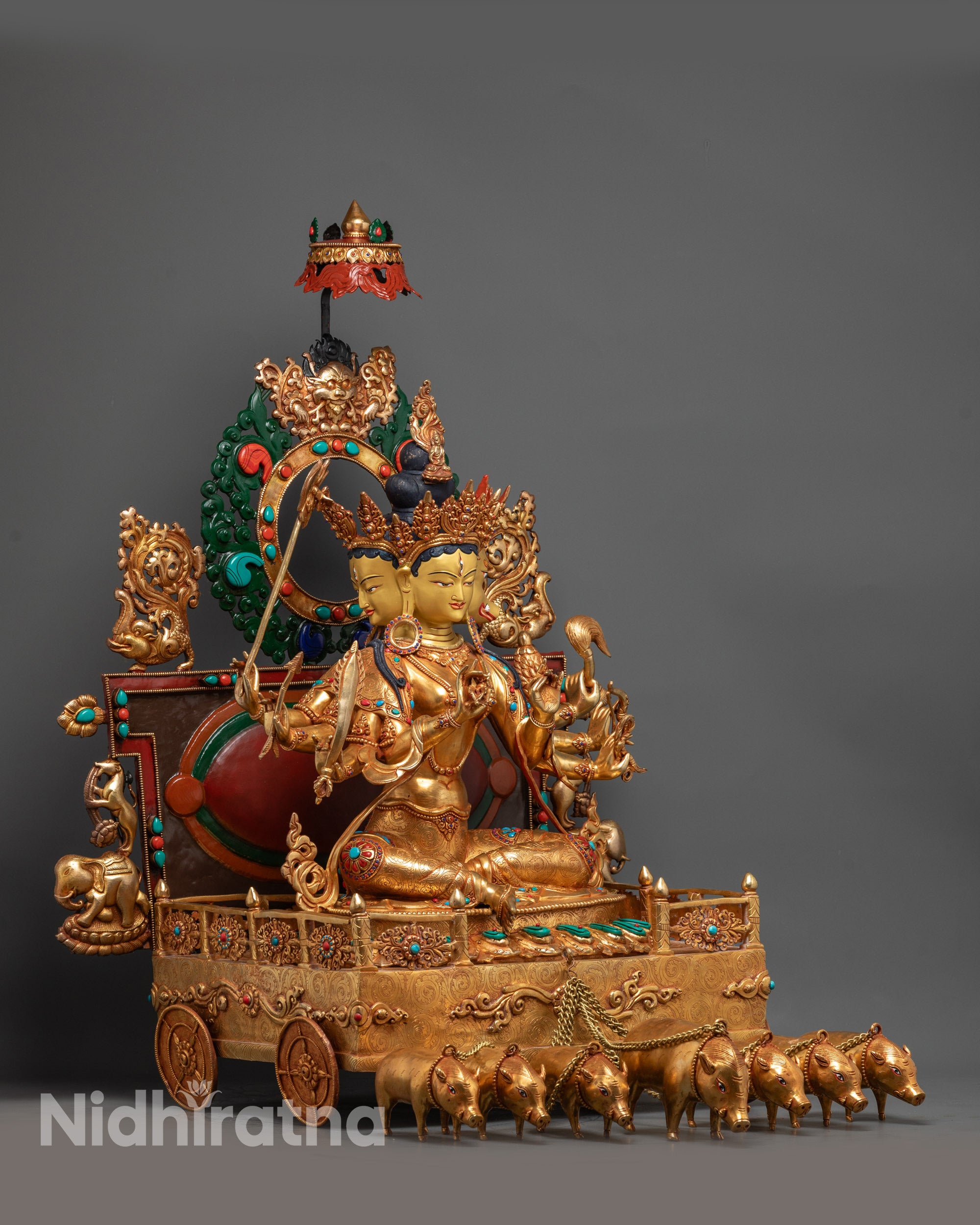 Side view of Marichi Statue on celestial chariot pulled by seven pigs