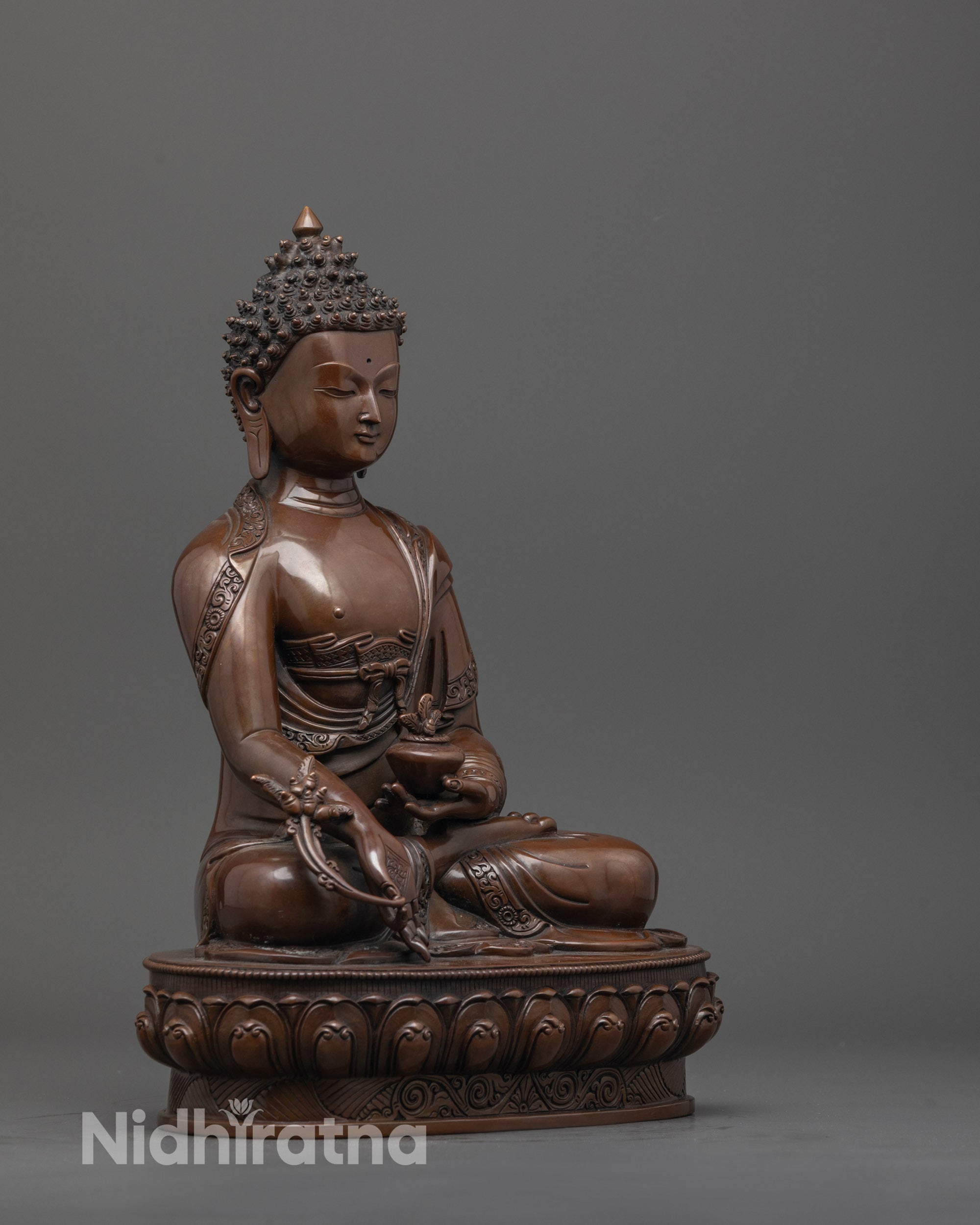 Side view of Medicine Buddha statue highlighting robe folds and detailed hand-carved elements
