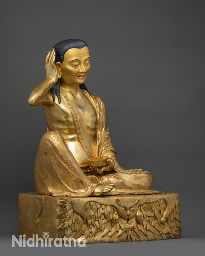 Side view of Milarepa seated on deer skin-draped pedestal holding kapala ritual cup
