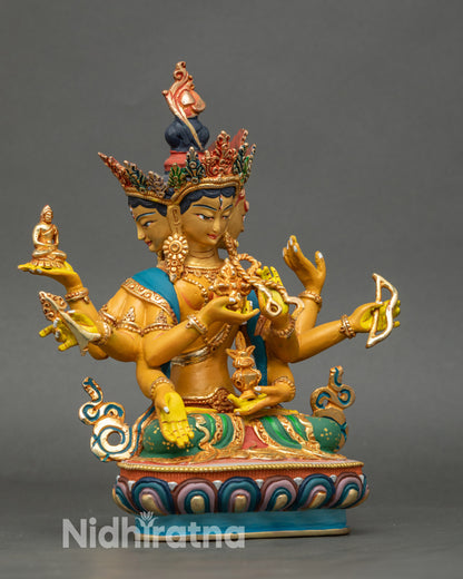 Side view of Namgyalma statue with eight arms holding sacred implements