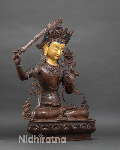 Side view of Nepalese Manjushri statue, chemically oxidized copper detailing