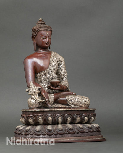 Side view of Nepalese Medicine Buddha statue seated on lotus throne, spiritual sculpture