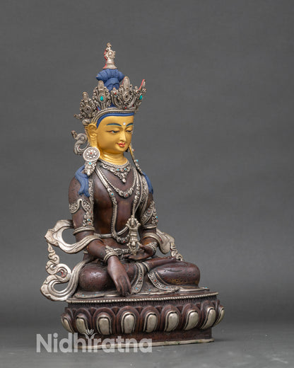 Side view of Nepalese Mitrugpa statue, silver-oxidized with 24K gold face