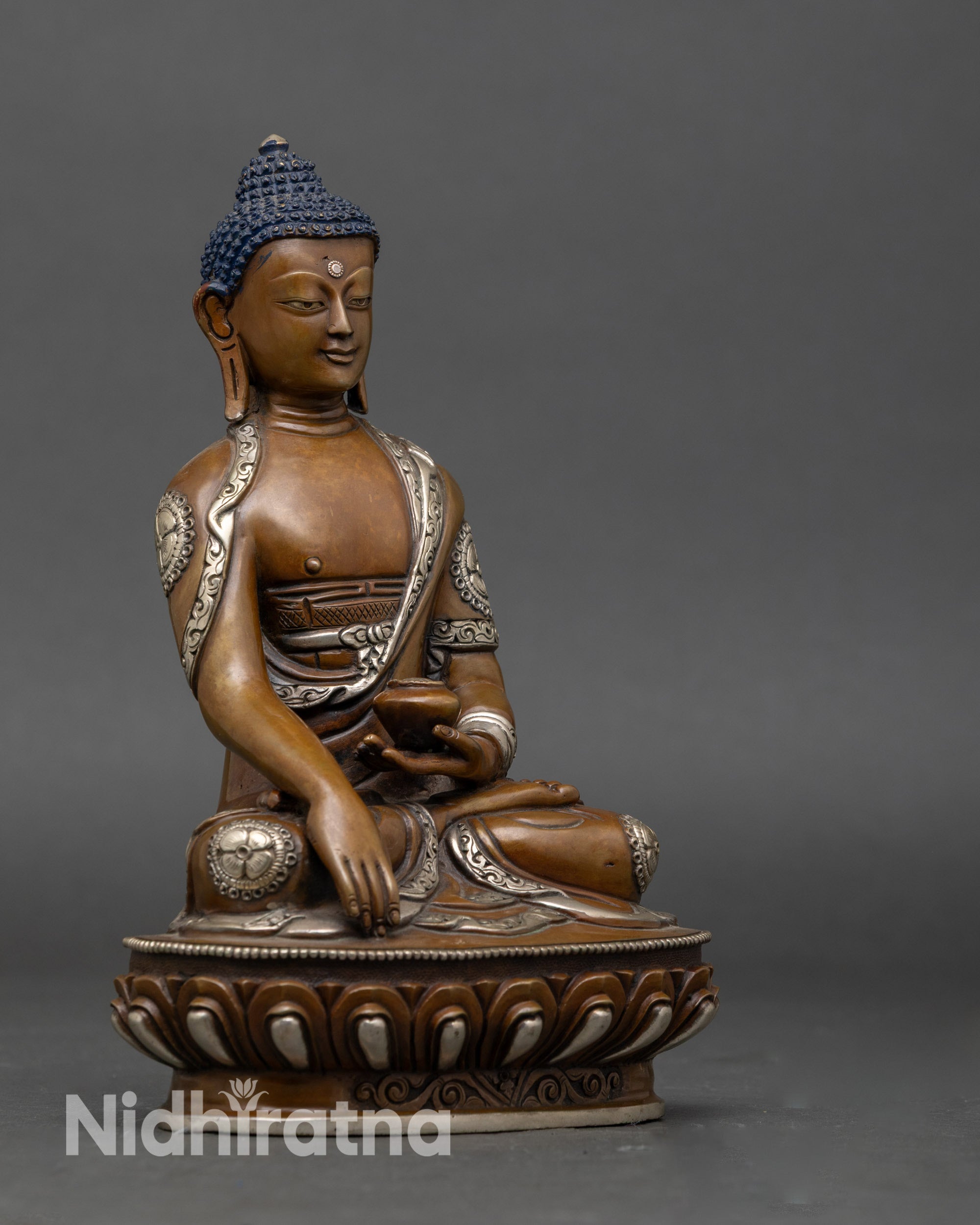 Side view of Nepalese Shakyamuni Buddha statue holding monk’s bowl, silver finish