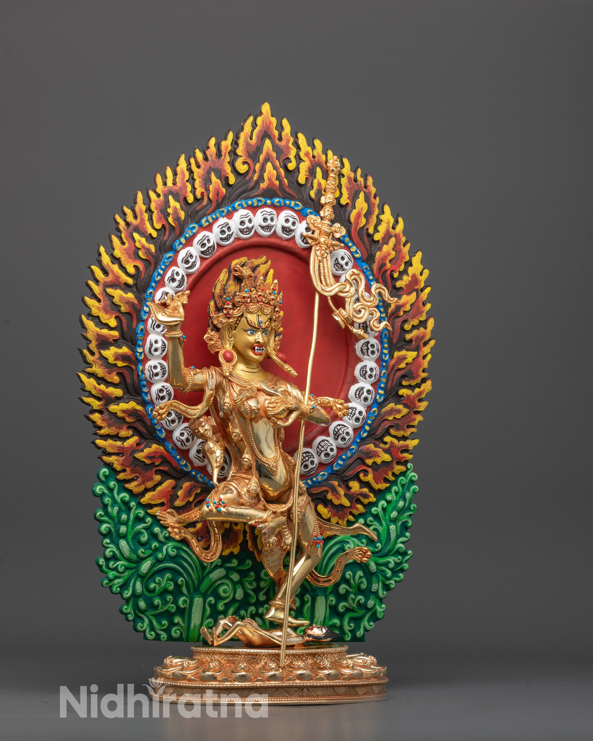 Side view of Nepalese Troma Nagmo Statue with dancing posture and flaming halo