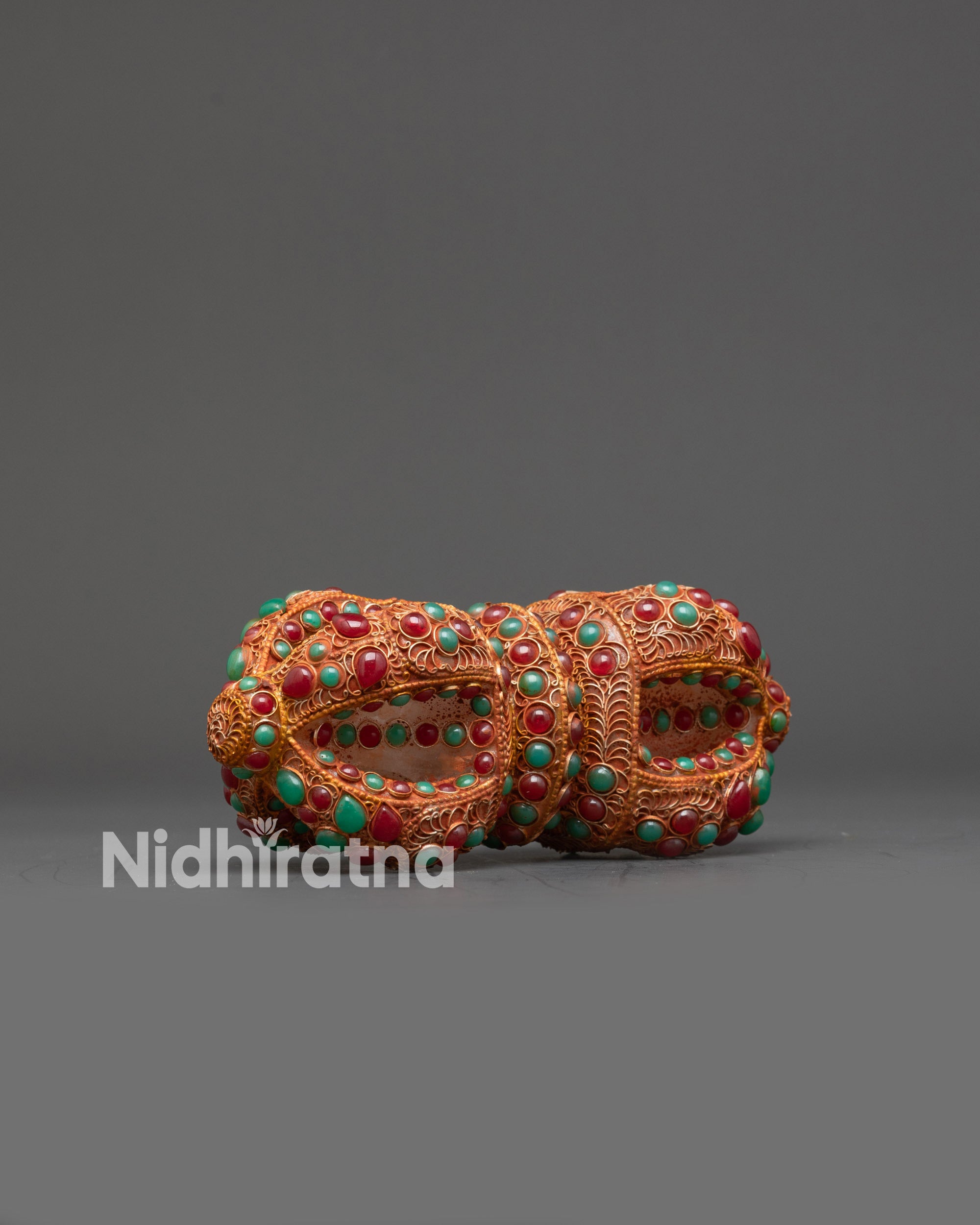 Side view of Nepalese Vajra with intricate gold and copper filigree details