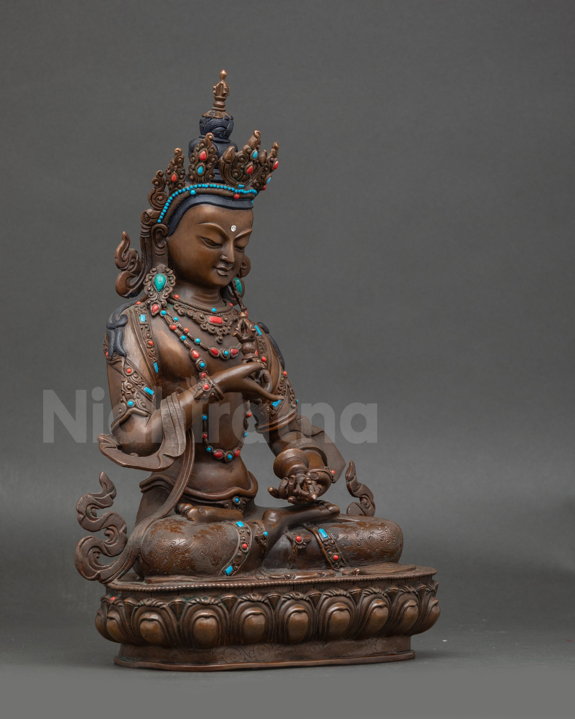 Side view of Nepalese Vajrasattva figurine with sacred bell and vajra