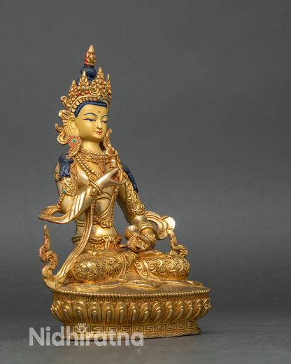 Side view of Nepalese Vajrasattva statue with intricate lotus seat and jewelry motifs