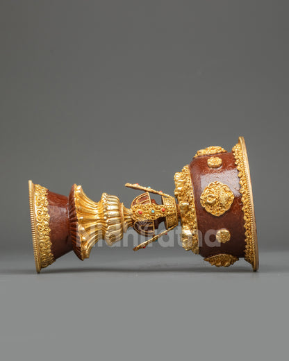 Side view of Nepalese gold-gilded copper butter lamp set for altar decor