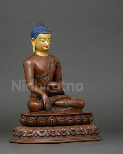 Side view of Nepalese handcrafted Shakyamuni Buddha holding monk’s alms bowl