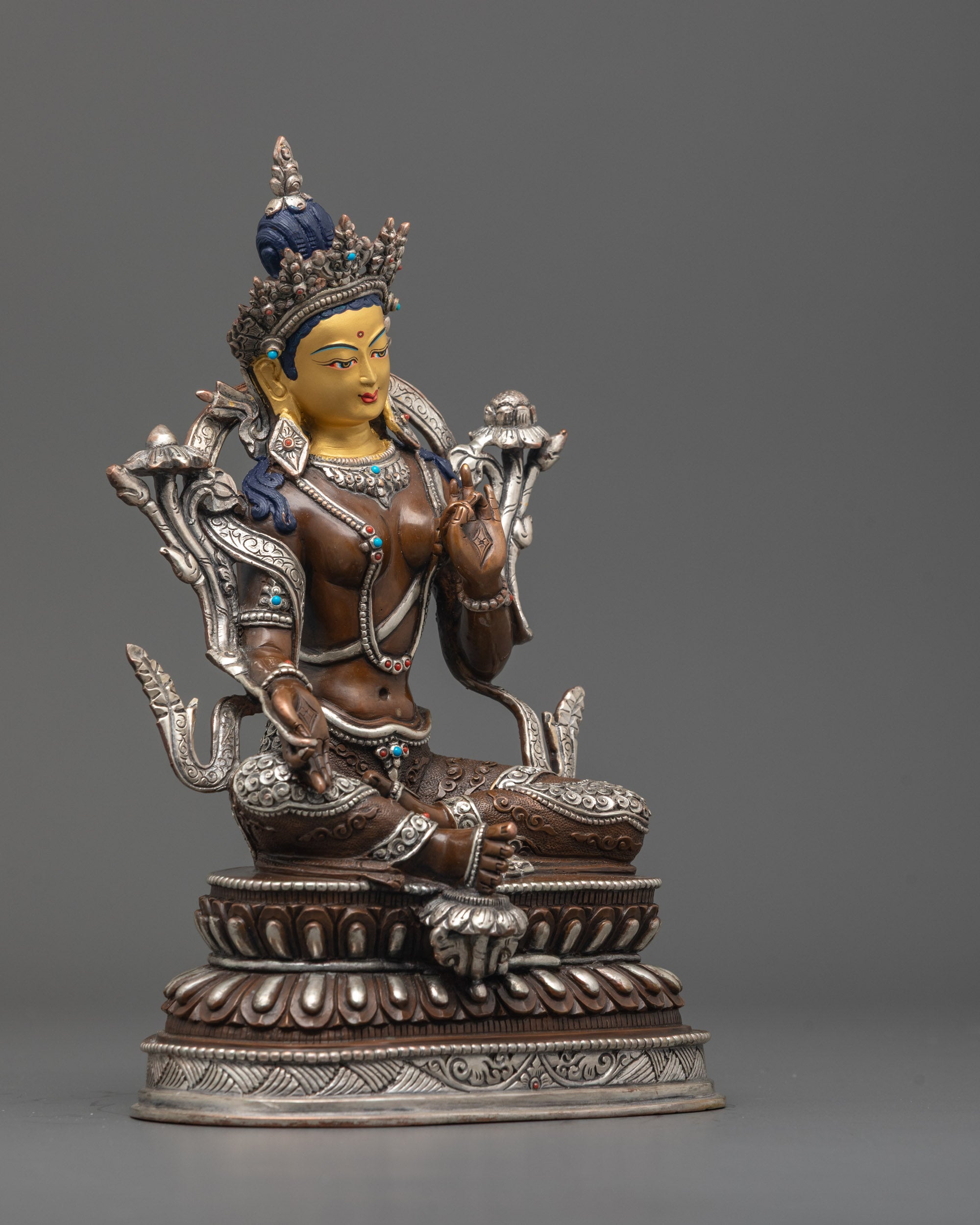 Side view of Oxidized Green Tara Statue showing royal ease pose and lotus throne.