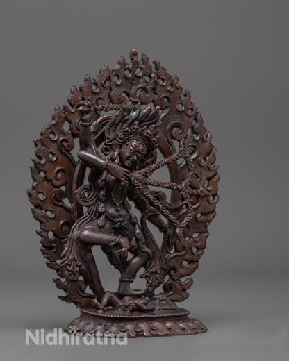 Side view of Oxidized Kurukulla Statue showing flowing robes and wrathful posture