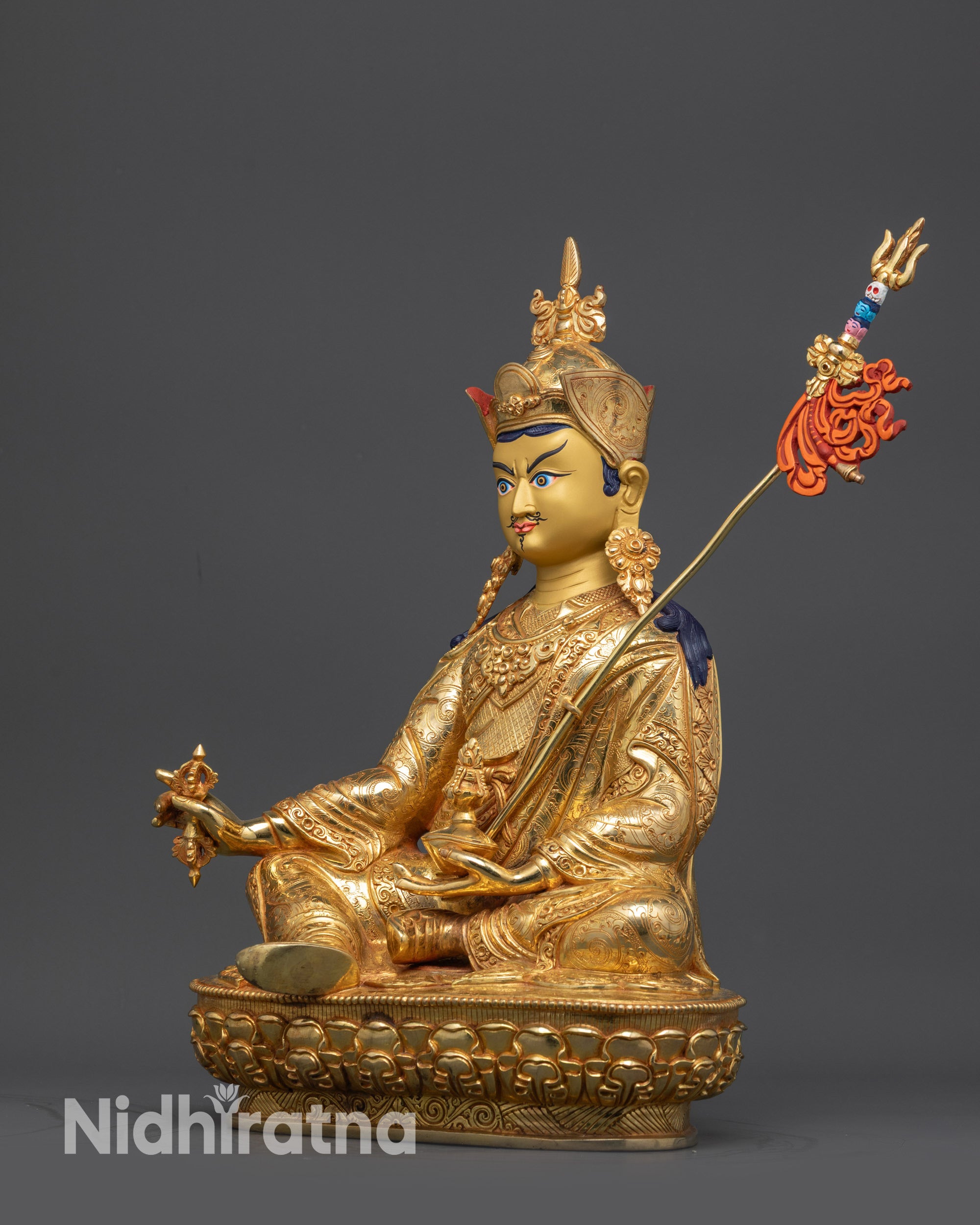 Side view of Padmasambhava Statue with vajra, kapala, and khatvanga trident details