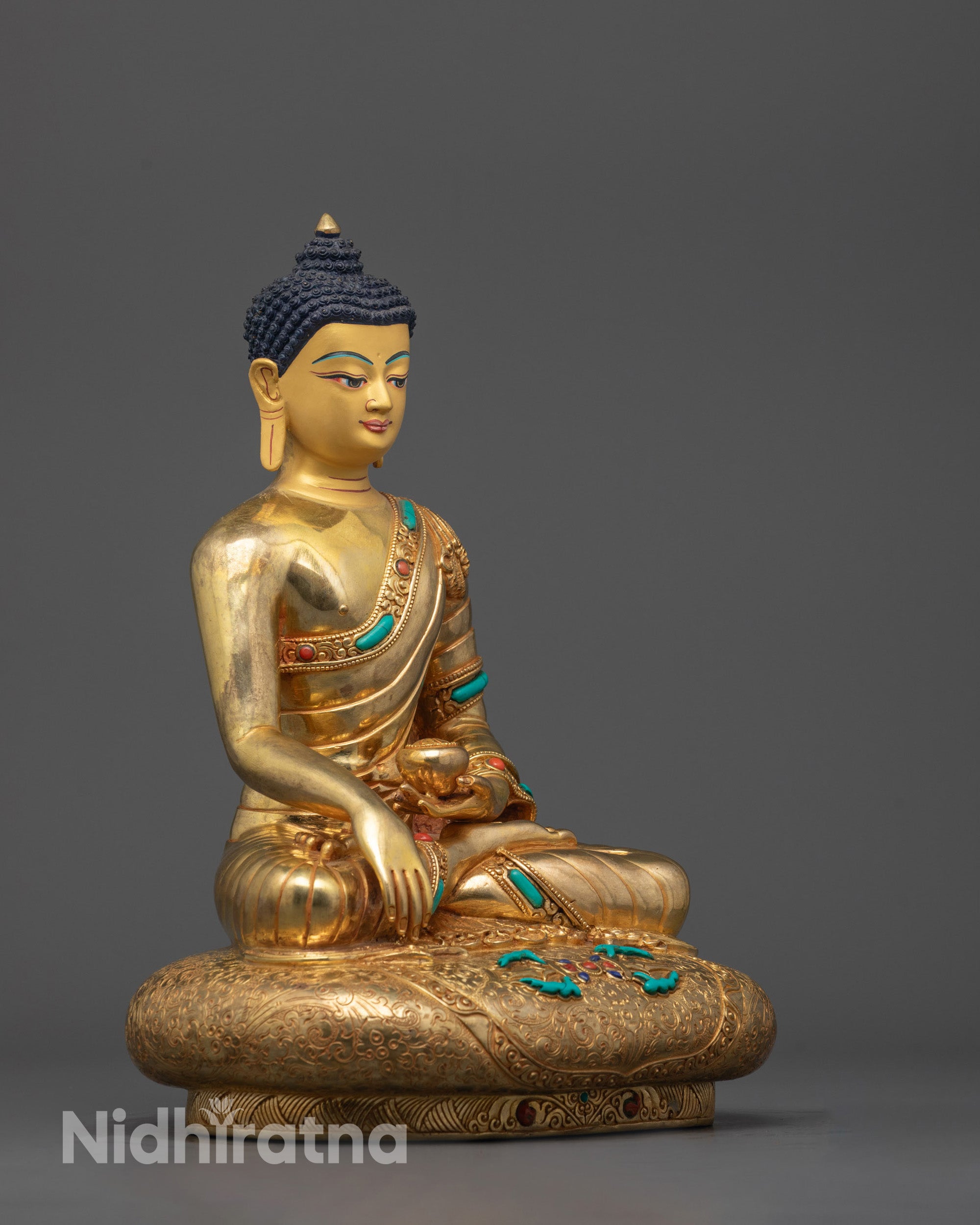 Side view of Seated Shakyamuni Buddha in bhumisparsha mudra holding a monk’s bowl