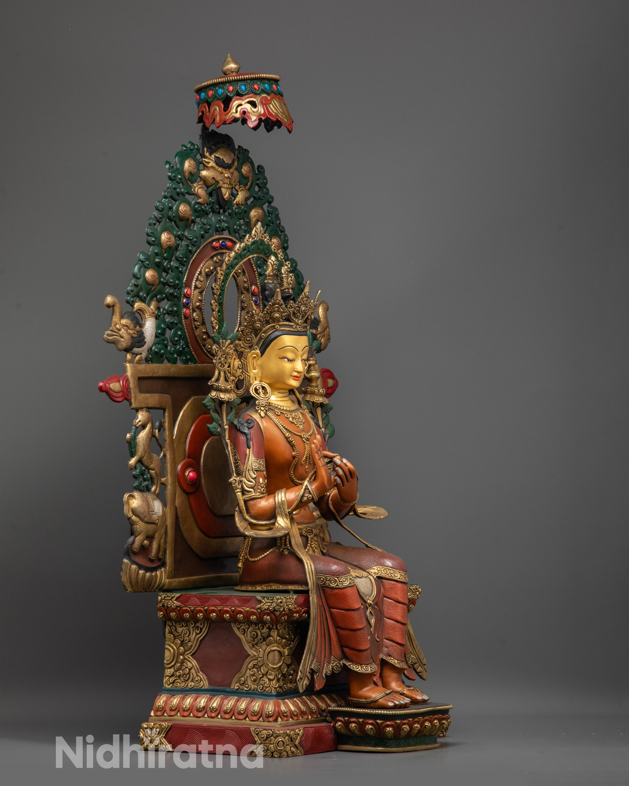 Side view of Serene Maitreya Buddha Statue showing floating robe and lion throne carvings