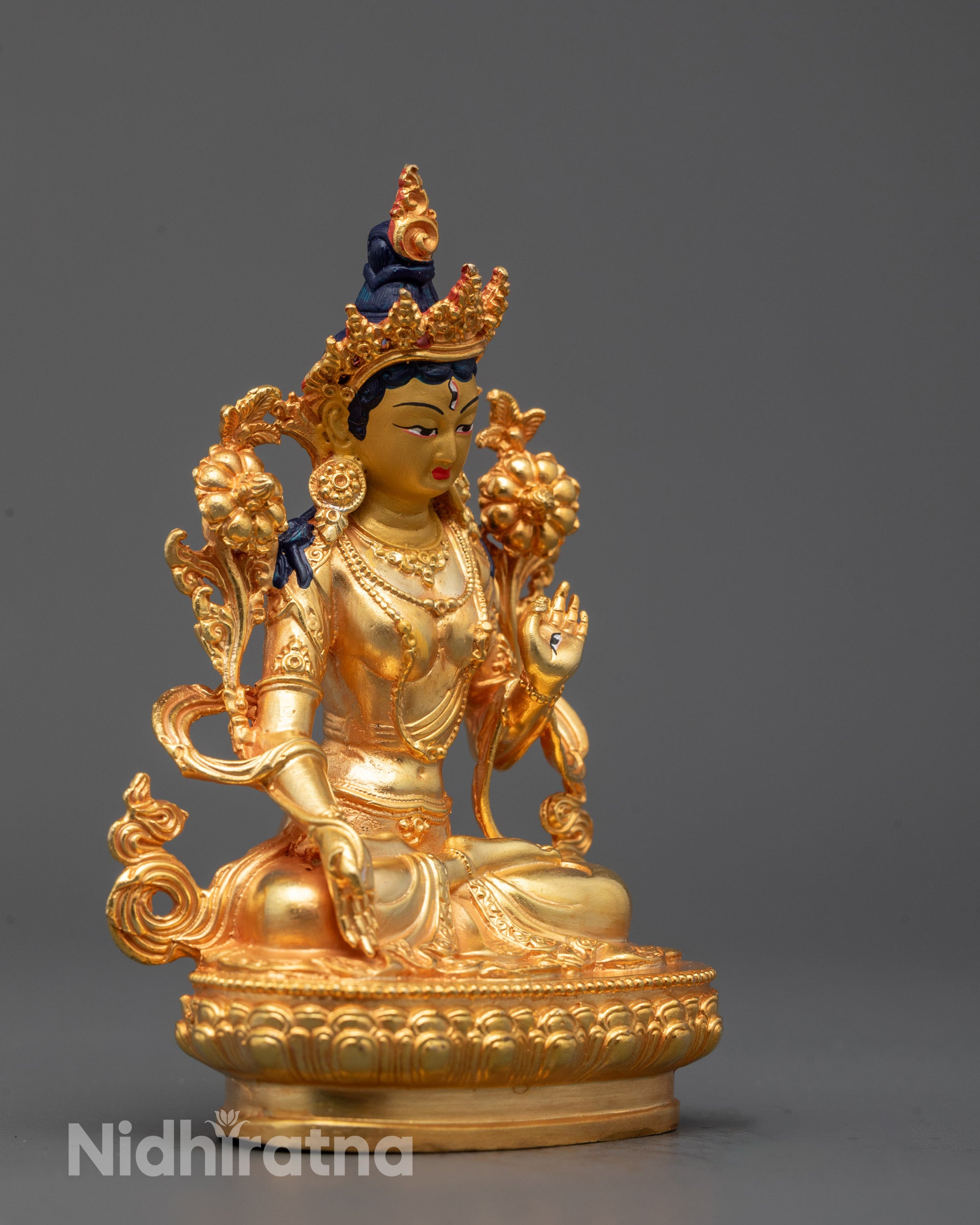 Side view of Seven-eyed White Tara Buddhist statue in silver plating representing healing
