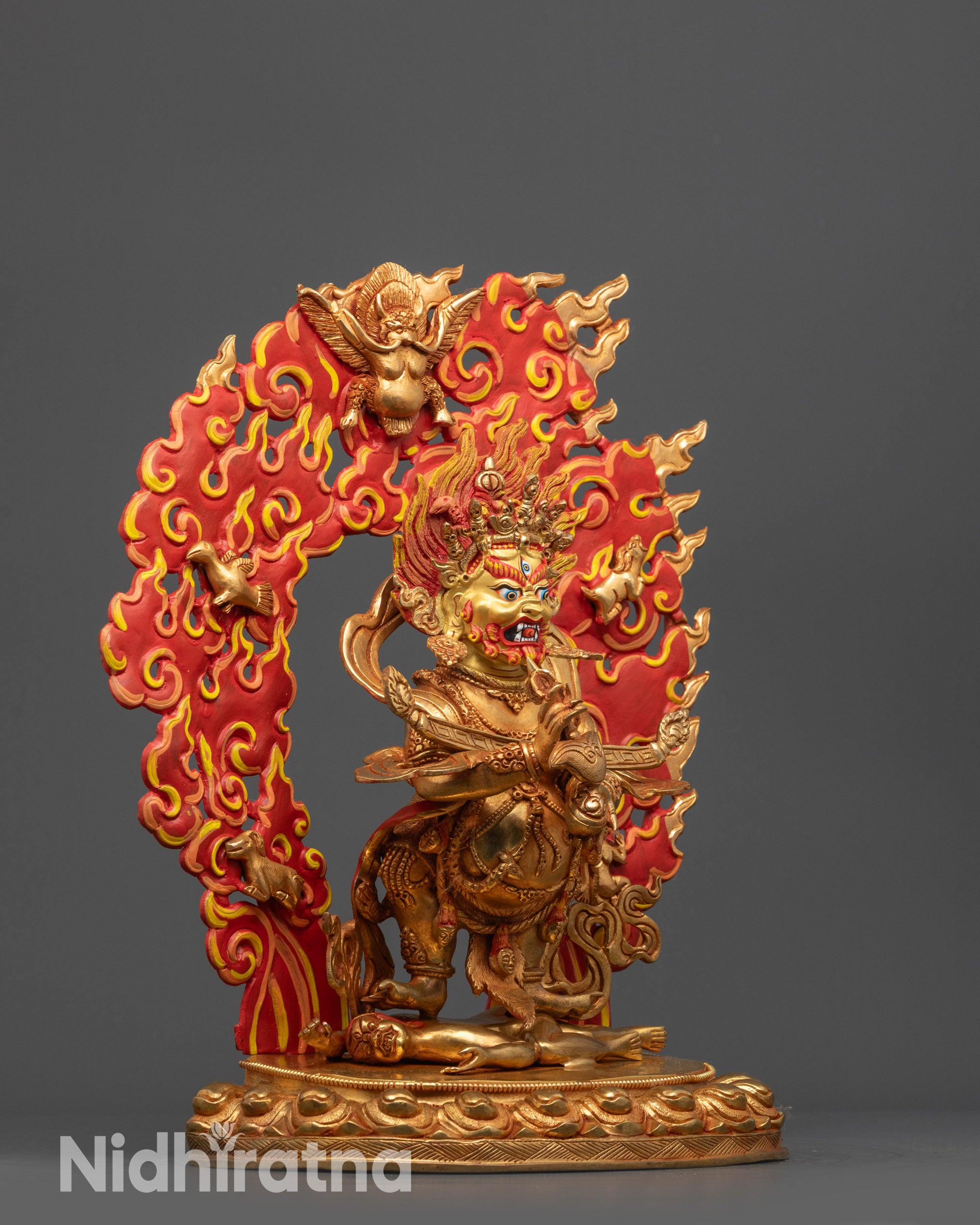 Side view of Shakya Mahakala Statue holding kartika knife and Kapala with serpent garland
