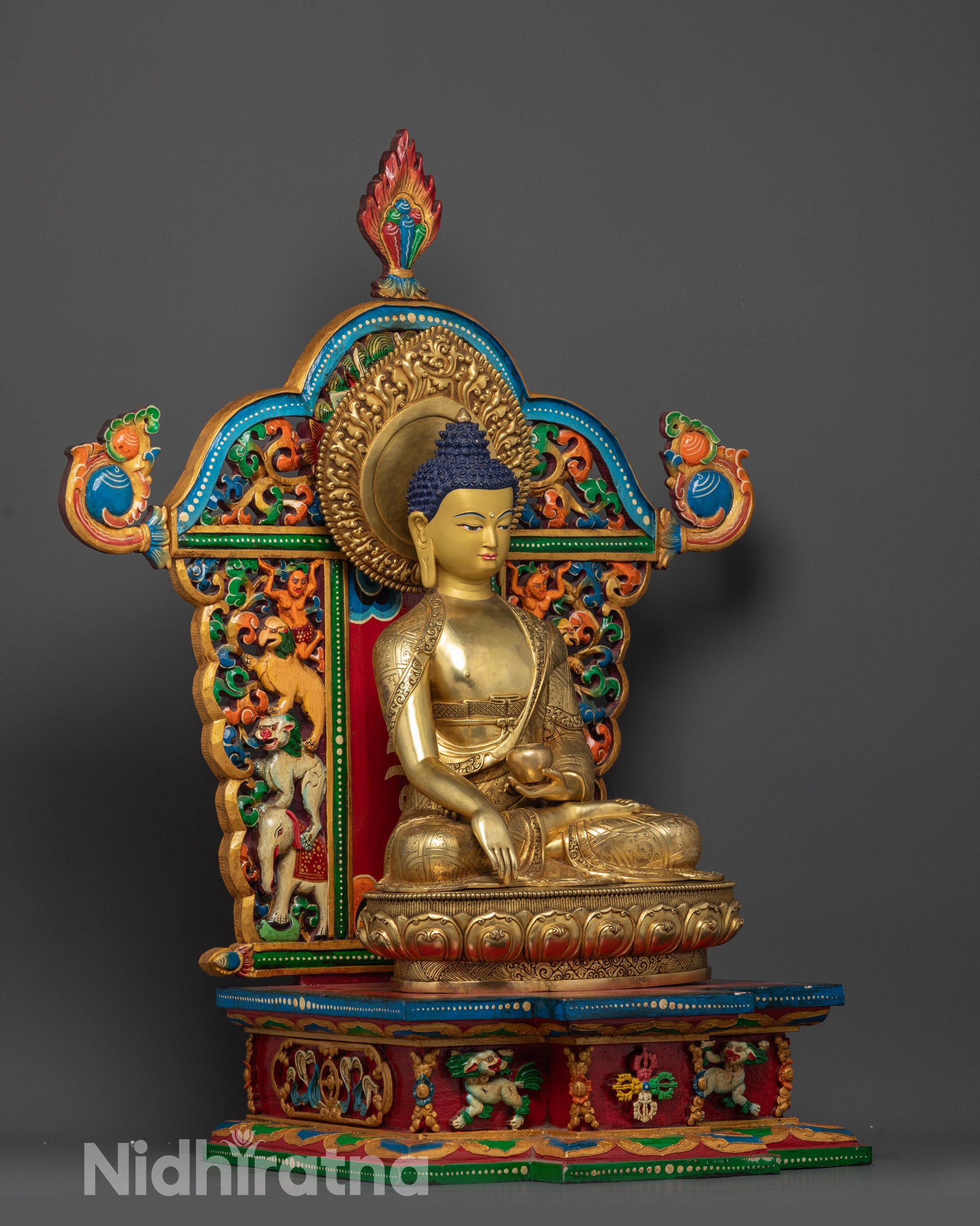Side view of Shakyamuni Buddha holding patra bowl seated on detailed lotus throne
