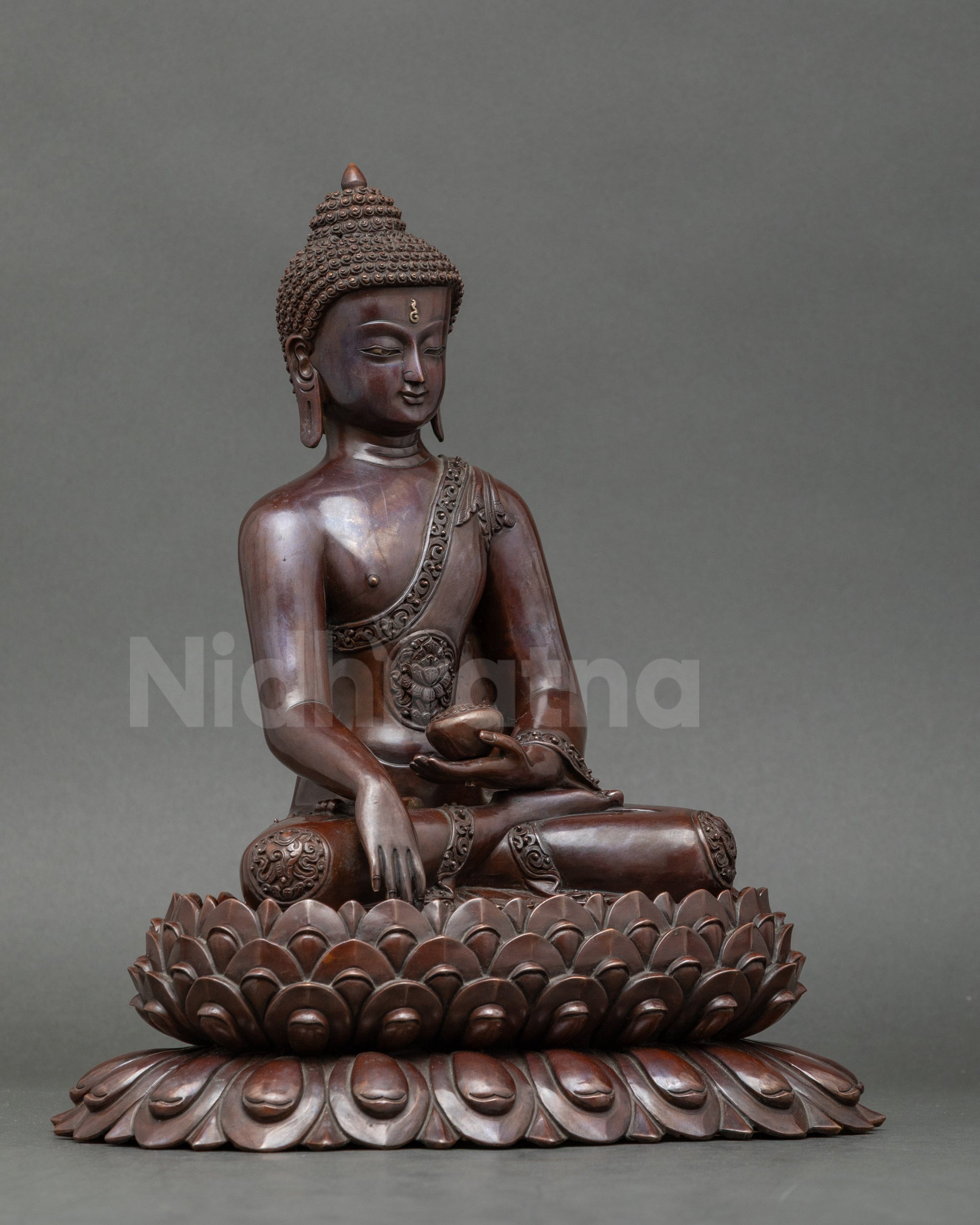 Side view of Shakyamuni Buddha sculpture holding Begging Bowl for spiritual reflection
