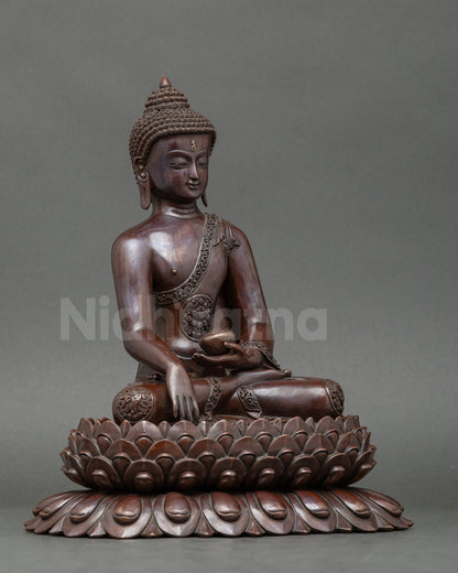 Side view of Shakyamuni Buddha sculpture holding Begging Bowl for spiritual reflection