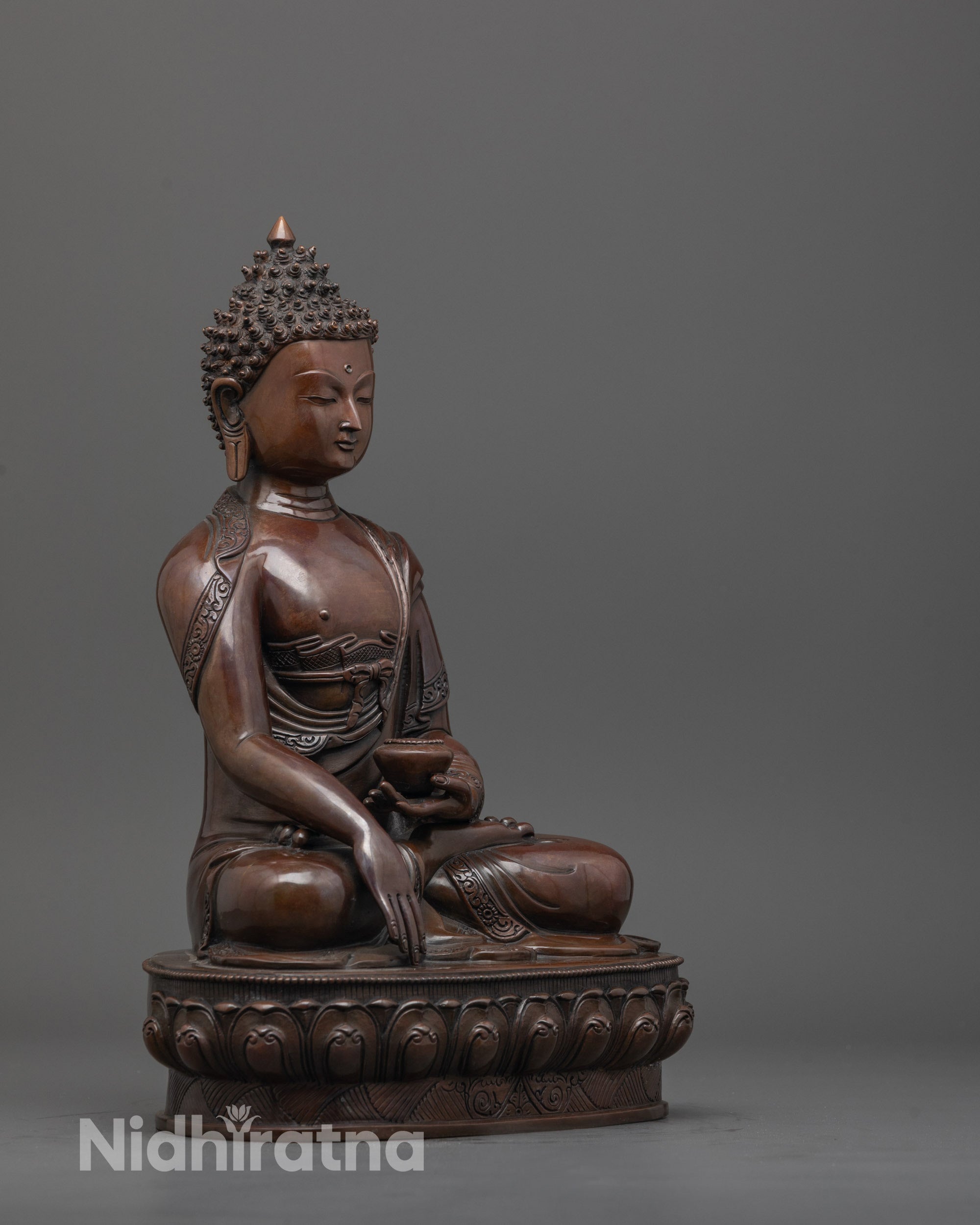 Side view of Shakyamuni Buddha statue seated in Bhumisparsha mudra on lotus base