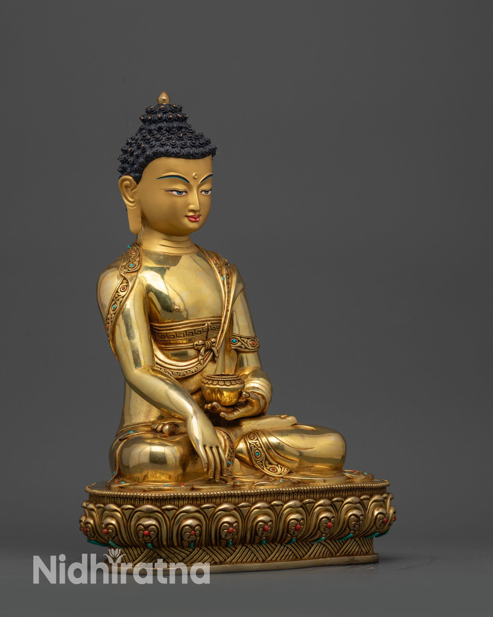 Side view of Shakyamuni Buddha statue showing intricate robes and lotus pedestal
