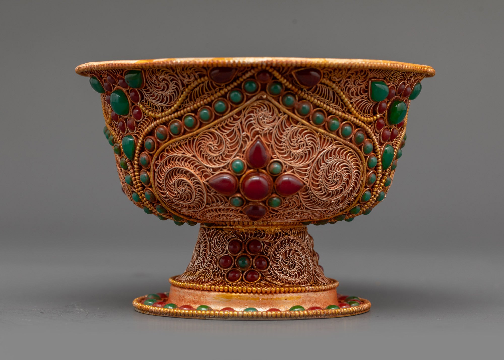 Side view of set of seven Water Offering Bowl highlighting gold filigree patterns
