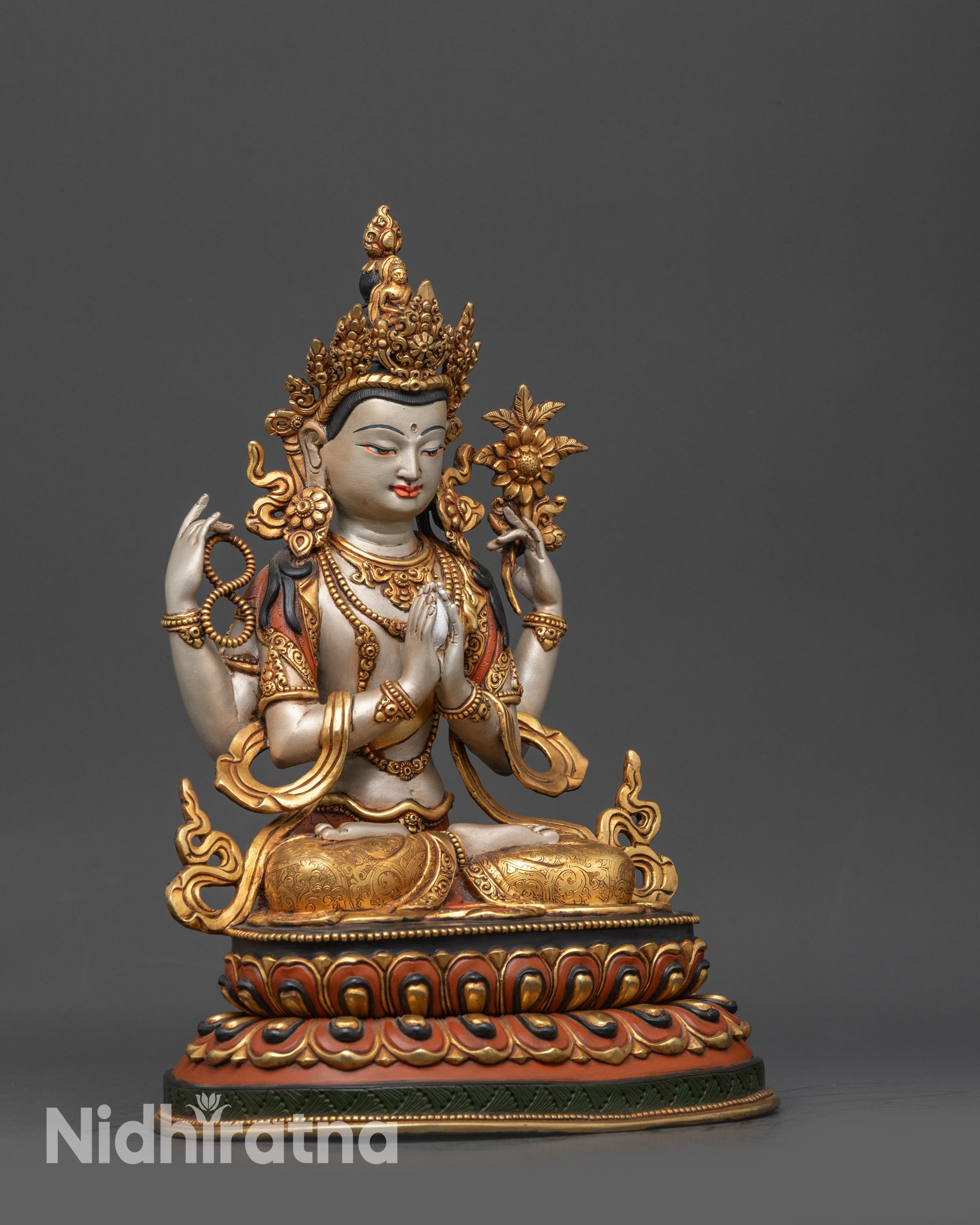 Side view of Tibetan Chenrezig Statue showing intricate patterned garments and posture