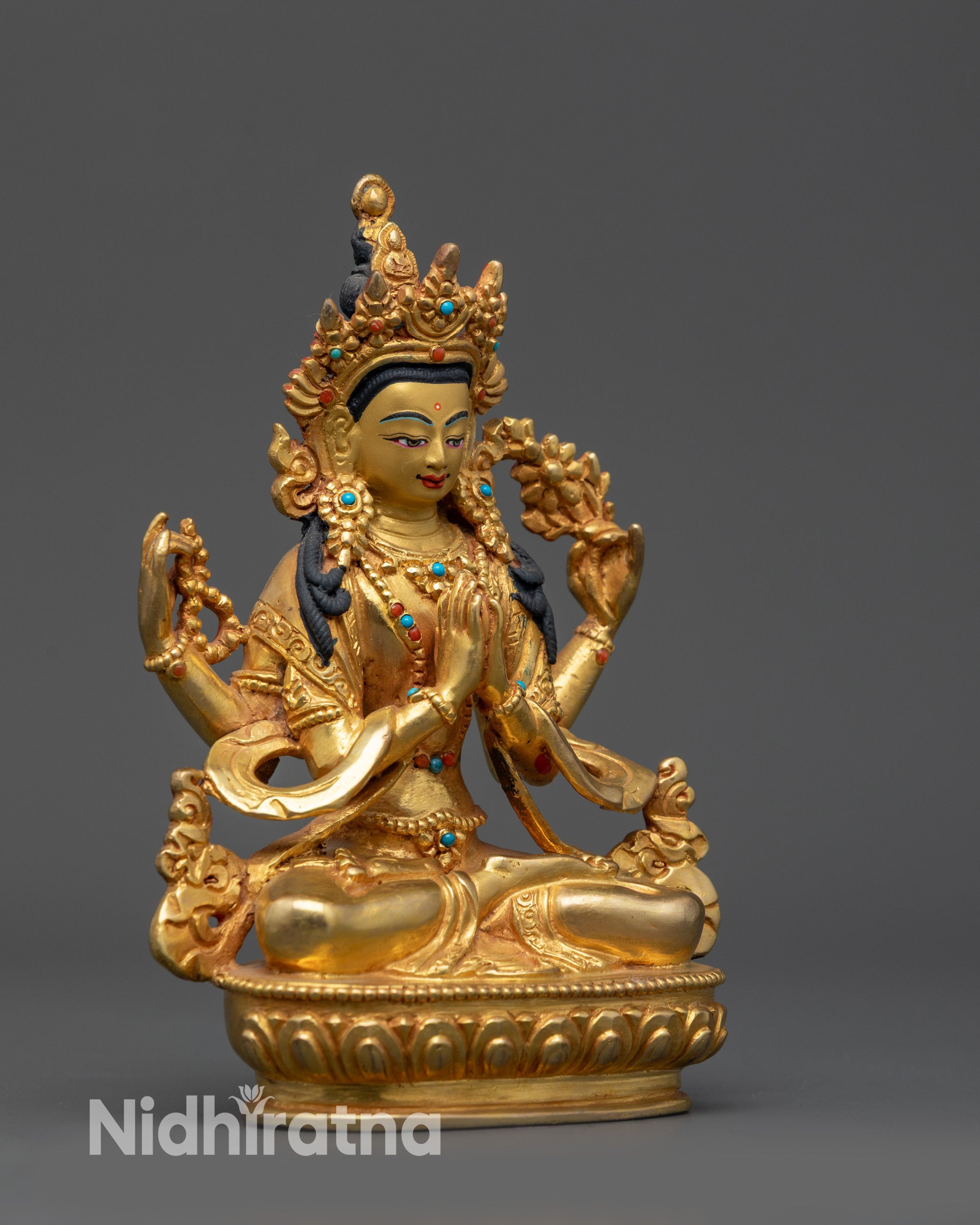Side view of Tibetan Chenrezig Statue with flowing robes and four-armed iconography
