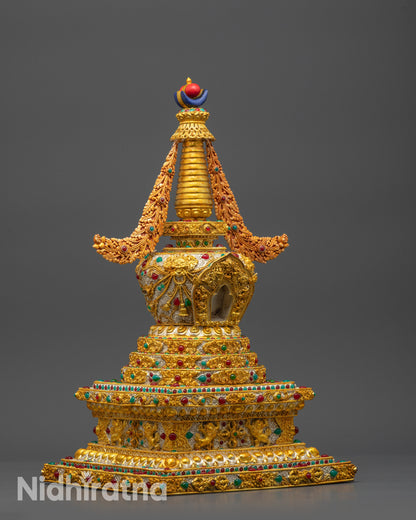 Side view of Tibetan Golden Stupa showcasing intricate silver filigree and patterns
