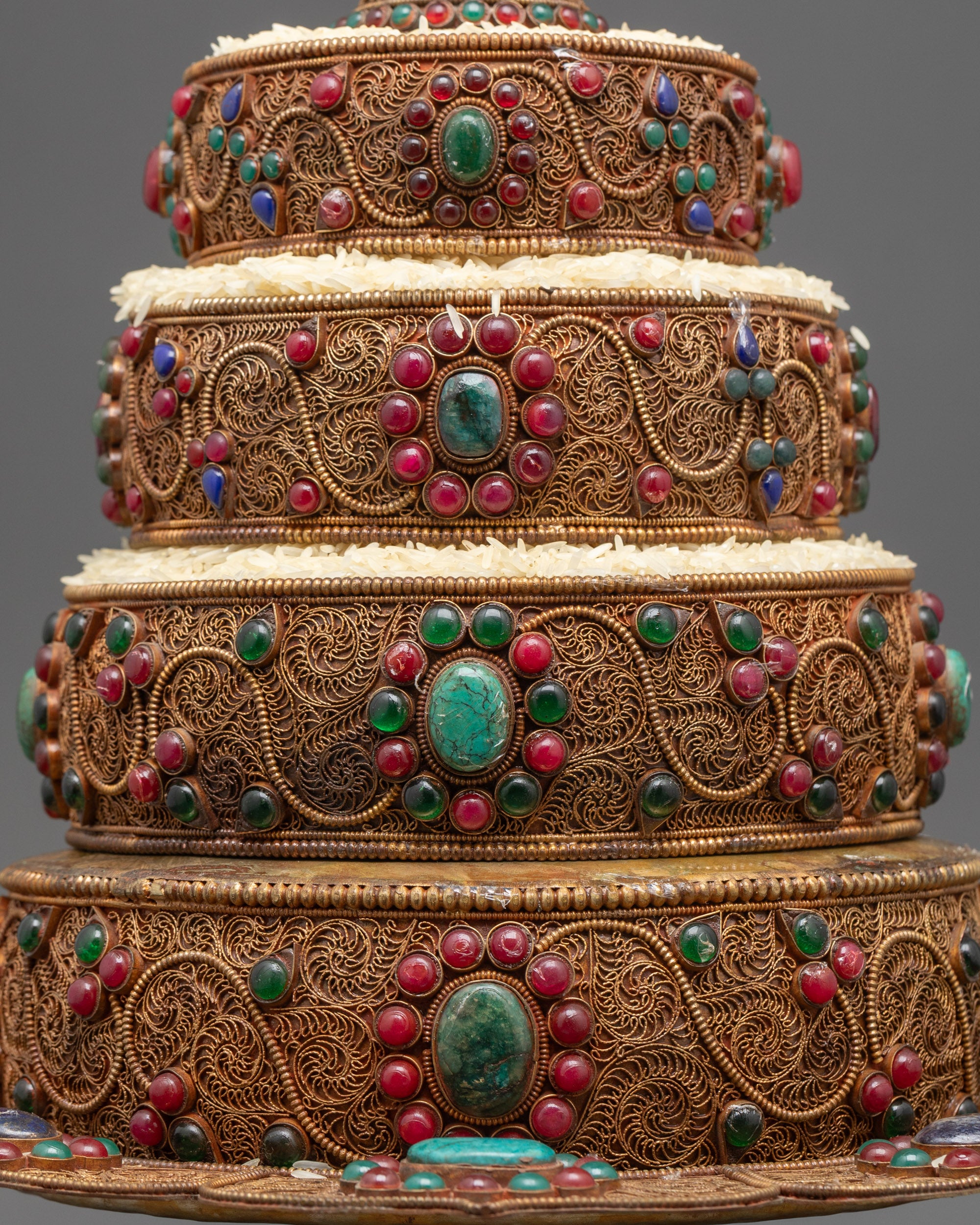 Side view of Tibetan Mandala Set highlighting copper body and colorful gemstones