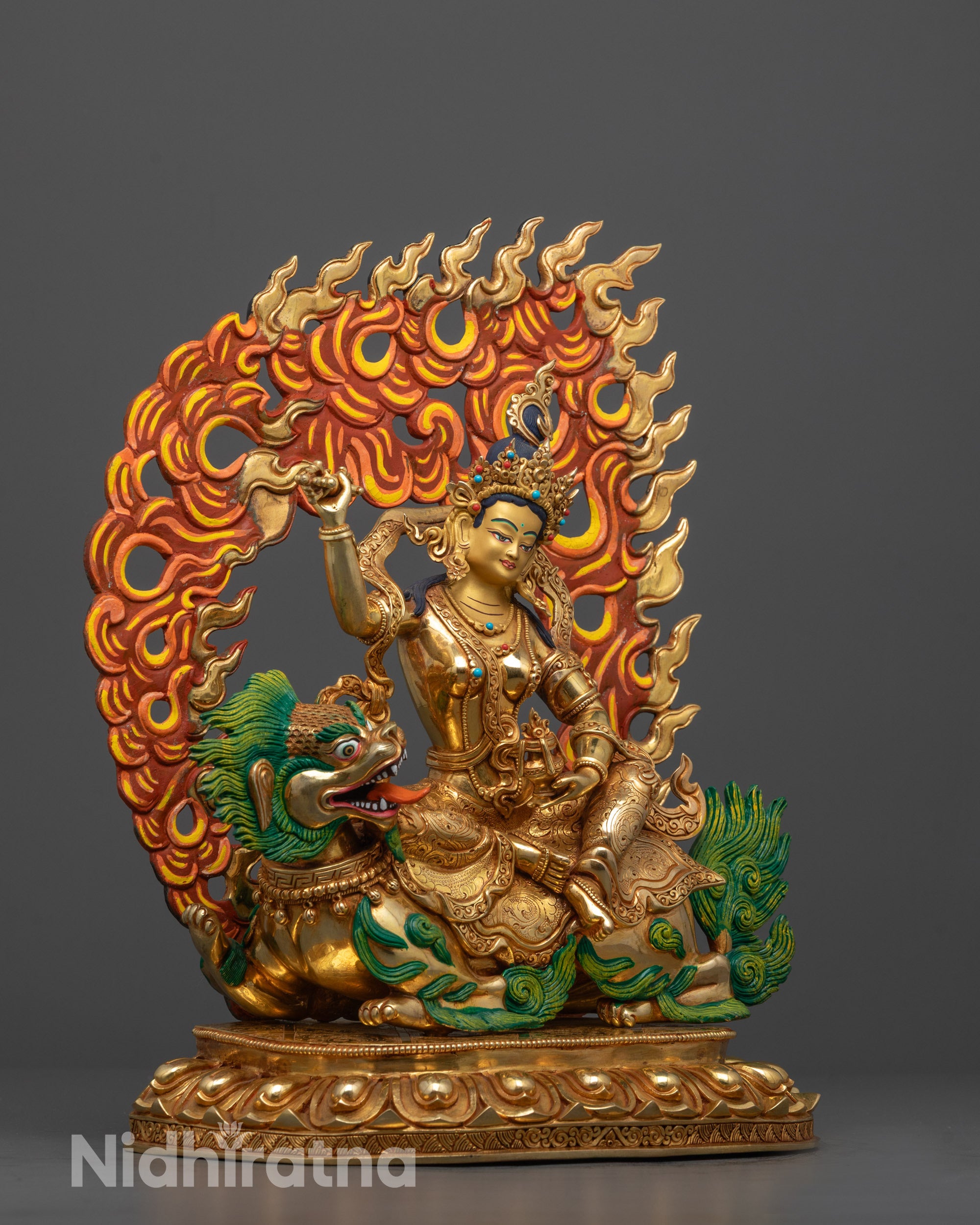 Side view of Tsheringma statue highlighting the gold-gilded copper robe, symbolic hand gestures