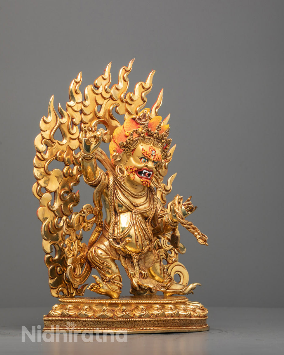 Vajrapani statue showing detailed hand-carved copperwork and intricate robe patterns.
