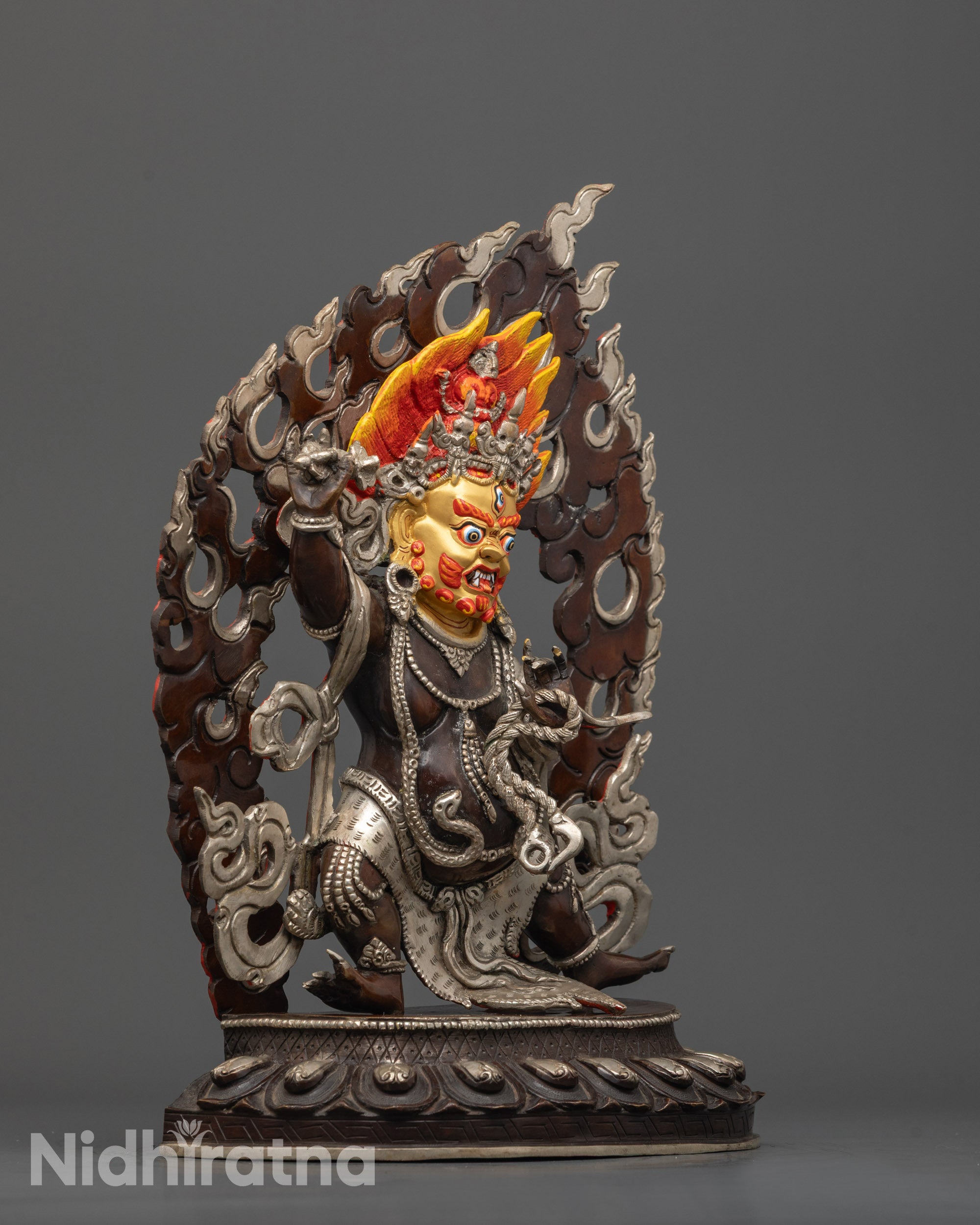 Side view of Vajrapani sculpture with oxidized copper body and swirling robe in fine detail