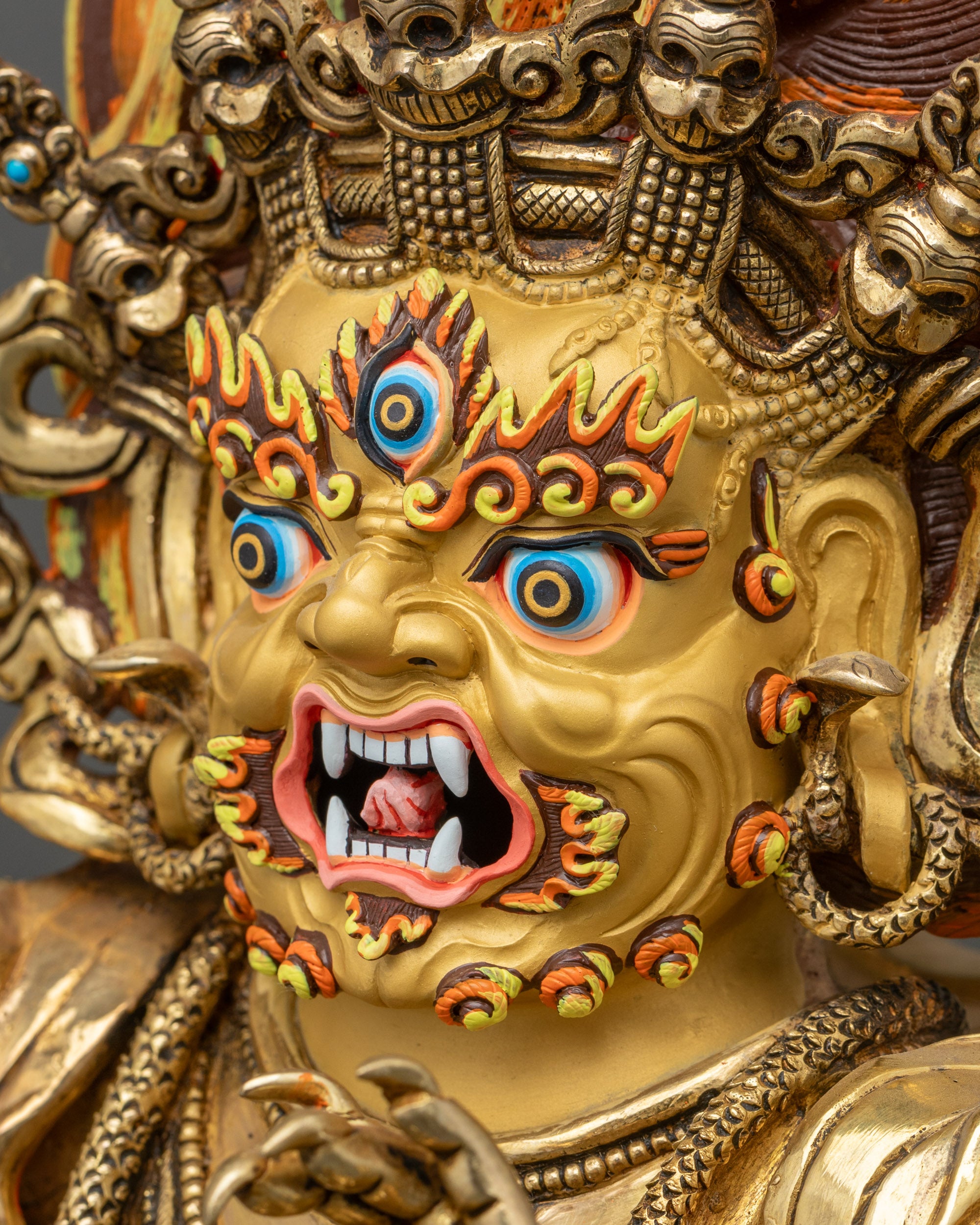 Side view of Vajrapani statue showing intricate carved robes and patterned garments