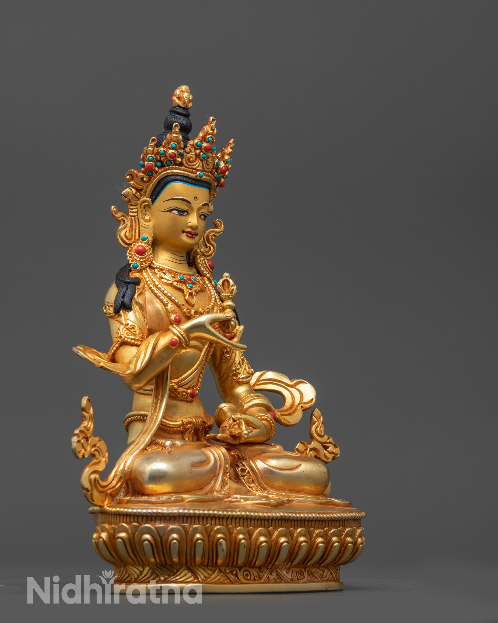 Side view of Vajrasattva Statue highlighting intricately carved floating robe and lower garment