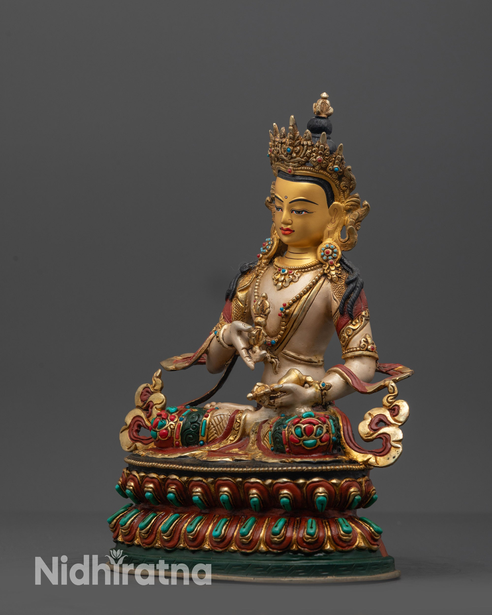 Side view of Vajrasattva Statue holding Dorje and bell with white-hued body and gold finish