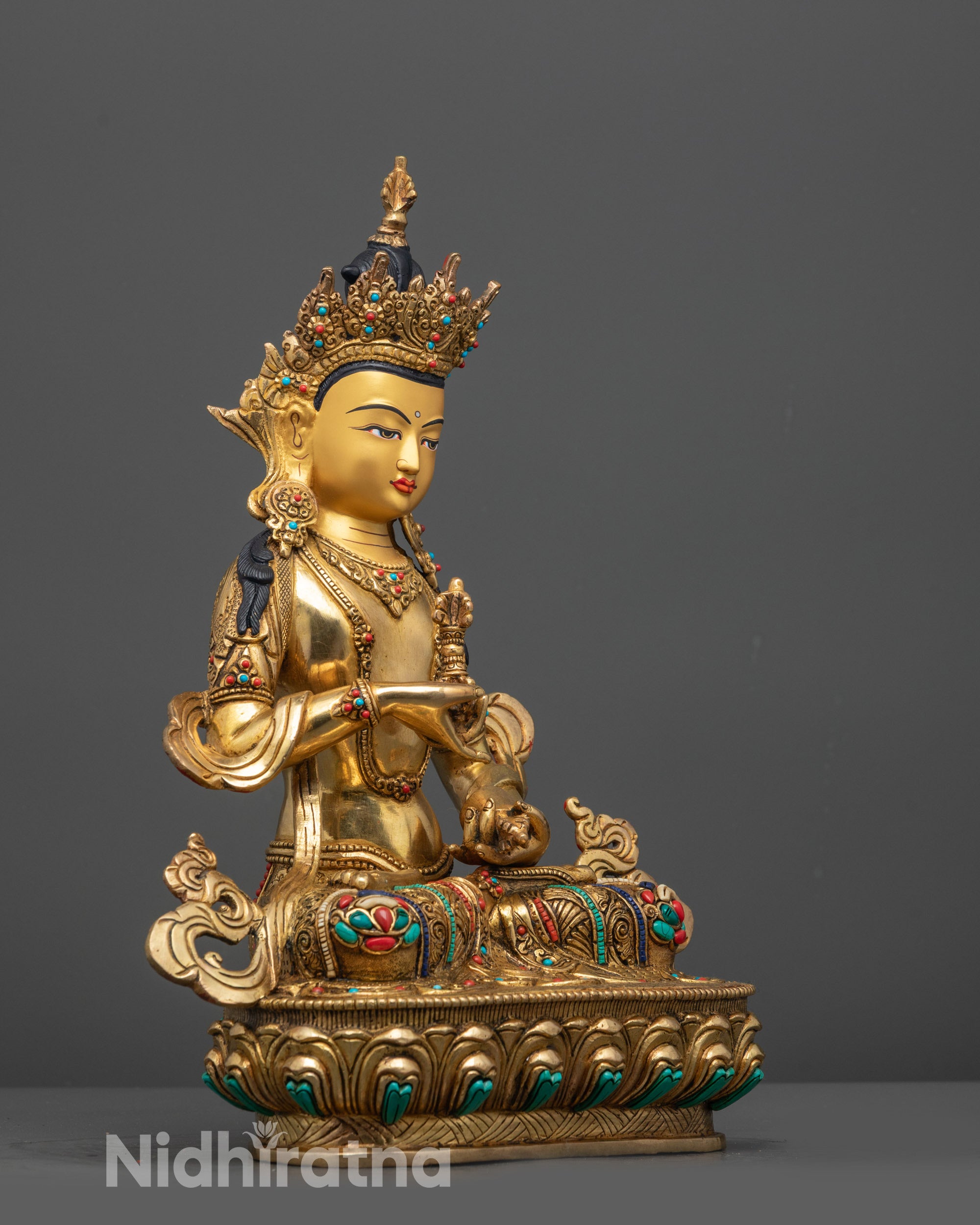 Side view of Vajrasattva Statue with floating robe, carved lower garment, and stone embellishments