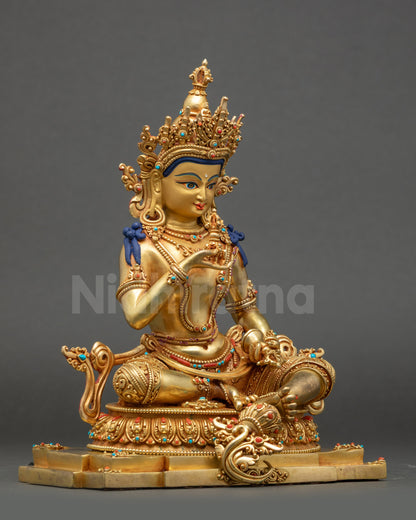 Side view of Vajrasattva holding vajra and bell atop lotus seat with filigree robe